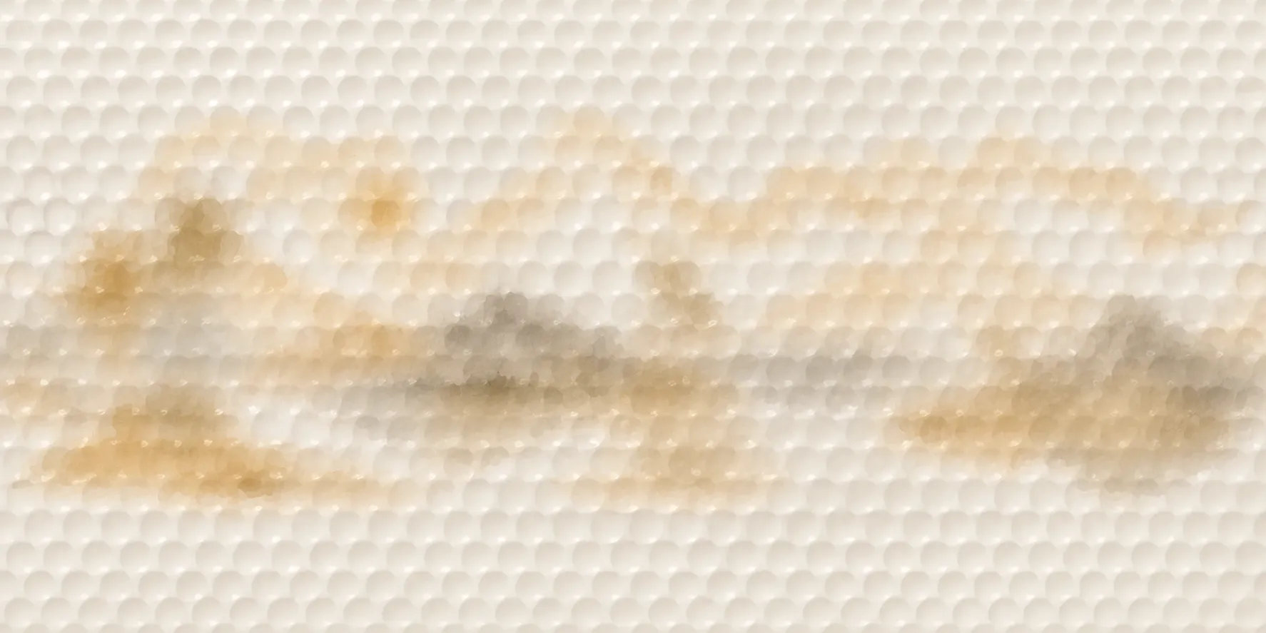 Panoramic gold-toned illustration with palms, mountains and a sun on a dimpled golf ball surface